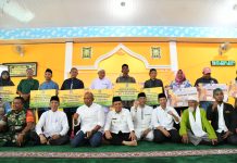 read news – Mubaligh dan Penyuluh Agama di Belakang Padang Dapat Bantuan dari Gubernur Kepri Penyaluran Bantuan disampaikan langsung Gubernur Kepri Ansar Ahmad (duduk bersila, dari nomor 5 dari kanan) Jum'at (9/12/2022) di Belakang Padang. Bantuan berupa honorarium diberikan kepada 105 orang, 7 orang penyuluh agama non PNS, dan 78 pemuka agama tetap pada rumah ibadah. Gubernur Ansar juga menyerahkan 30 unit alat perdagangan cool box, yang diperuntukan bagi pedagang pasar di Kecamatan Belakang Padang Kota Batam. (Foto : Abyaqsa Rhamadan - batamtv.com)