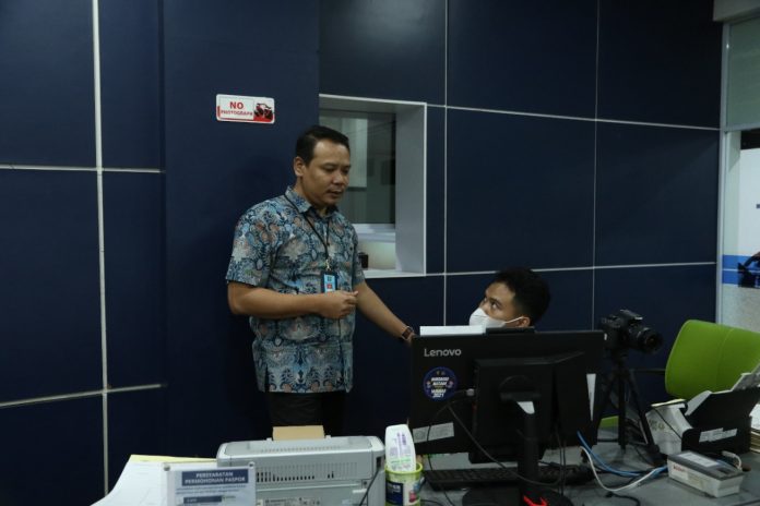 Kepala Seksi Dokumen Perjalanan Kantor Imigrasi Kelas 1 Khusus Batam, Doni Purwoko Hadi Sandra Dewa (berdiri) saat memberi penjelasan kepada staf pelayanan pembiatan paspor, Jumat (16/12/2022).  Imigrasi Kelas 1 Khusus  Batam, saat ini telah menaikkan kuota pembuatan paspor  menjelang akhir tahun. Mereka selalu disibukkan dengan pengurusan paspor bagi warga yang hendak berlibur ke luar negeri . (Foto : Muhammad Amin - batamtv.com) 