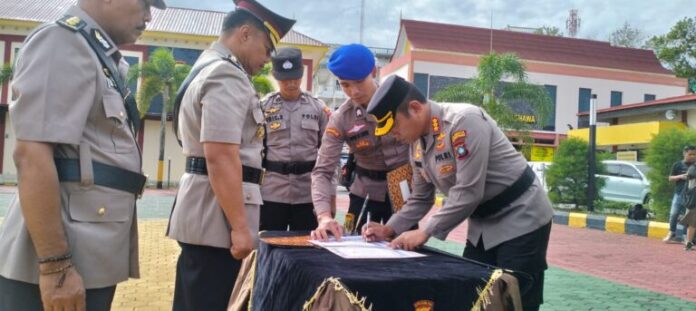Kapolresta Tanjungpinang Kombes Pol H.Ompusunggu (kanan) menandatangani naskah aertijab Kapolsek . (Foto : dwi susilo - batamtv.com)