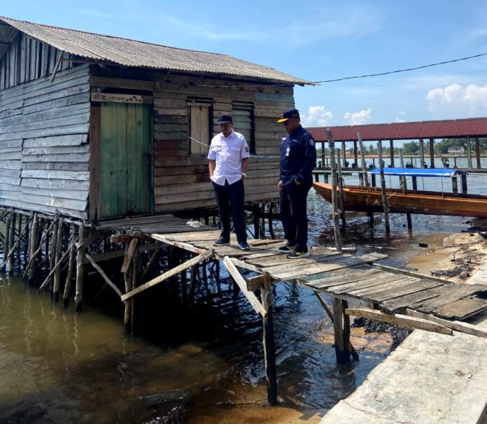 (Foto : muhammad amin - batamtv.com) Anggota Komisi 3 DPRD Propinsi Kepri Yusuf SMn MM (baju putih) saat berada di pantai yang tercemar minyak hitam . (Foto : muhammad amin - batamtv.com)