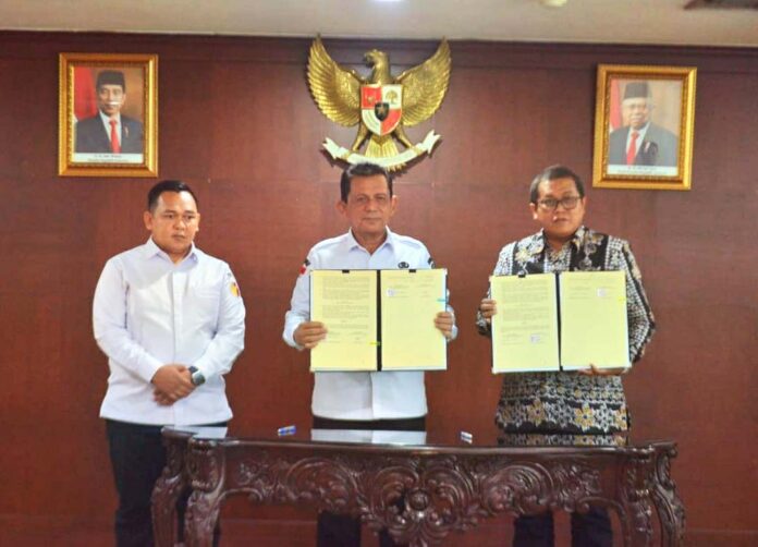Gubernur Kepri Ansar Ahmad (tengah) saat menandatangani Naskah Perjanjian Hibah Daerah (NPHD) dengan Komisi Pemilihan Umum (KPU) dan Badan Pengawas Pemilu (Bawaslu) Provinsi Kepulauan Riau, Rabu (1/11), di Aula Graha Kepri Kota Batam. (Foto : abdi perdana - batamtv.com)